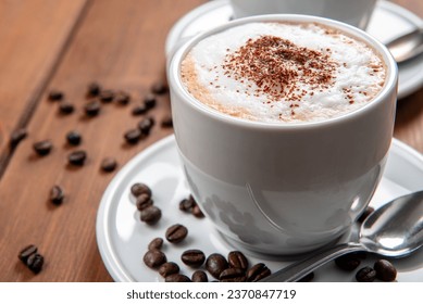 Cup with hot cappuccino with foam and cocoa powder, italian breakfast 
