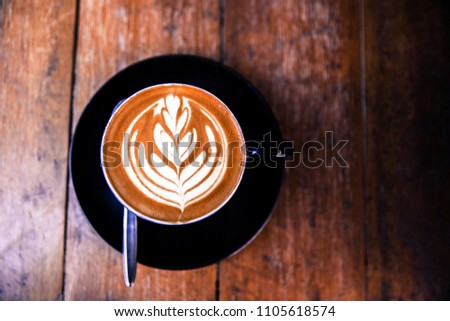 Cup of hot cappucino on wooden table background. Flat lay style