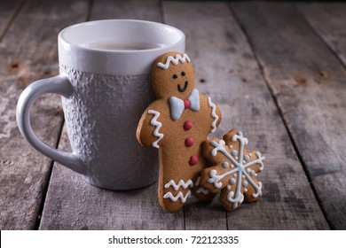 Cup of hot chocolate or cocoa with gingerbread cookie christmas composition on vintage wooden table background. - Powered by Shutterstock