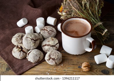 A cup of hot chocolate, coffee cookies, with sweet marshmallows, a bouquet of flowers, a vintage table.