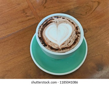 Cup Of Hot Chocolate And Latte Art Heart Shape On Wood Table