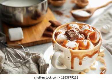 Cup Of Hot Chocolate With Marshmallows And Caramel On Table