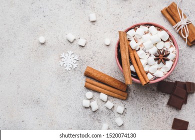 Cup of hot chocolate with marshmallows and cinnamon on light background - Powered by Shutterstock