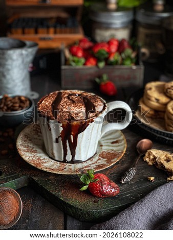 A cup of hot chocolate on a wooden board