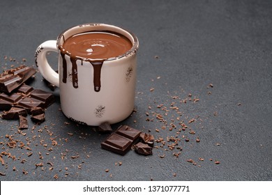 Cup Of Hot Chocolate And Pieces Of Chocolat On Dark Concrete Background