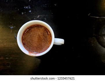 A cup of hot chocolate with stain of  lipstick on wooden table - Powered by Shutterstock