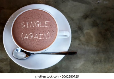 A cup of hot chocolate with text written SINGLE (AGAIN), concept of being single again after a breakup, got out of relationship or have lived the single life for a prolonged period of time - Shutterstock ID 2062380725