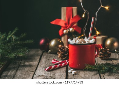 Cup Of Hot Cocoa With Marshmallows On Wooden Table With Christmas Fir Tree