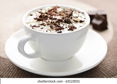 Cup of hot cocoa with shaved chocolate and whipped cream - Powered by Shutterstock