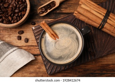 Cup Of Hot Coffee With Aromatic Cinnamon On Wooden Table, Flat Lay