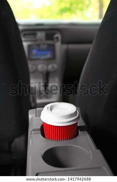 Cup of hot coffee in\
car