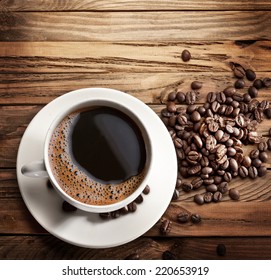 Cup Of Hot Coffee On A Old Wooden Table. Top Shot.