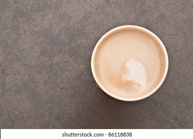 A Cup Of Hot Coffee In Paper Cup Taken From The Top View With Creamy Milk Inside