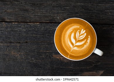 A Cup Of Hot Latte Art Coffee On Wooden Table 