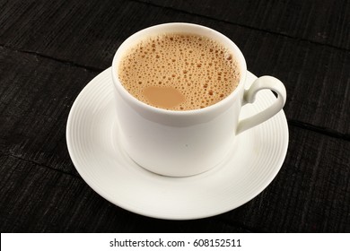 Cup Of Hot Milk Tea On A Wooden Table.