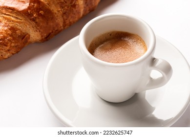 Cup of hot neapolitan espresso with brioche, italian breakfast