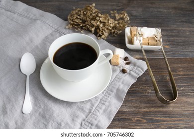 Cup  of hot steaming black coffee with sugar cubes on wooden table. - Powered by Shutterstock