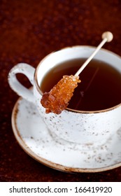 Cup Of Hot Tea And Rock Candy Sugar Stick, Selective Focus