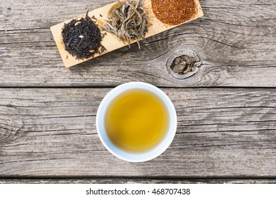 Cup Of Japanese Tea And Crops On Bambbo Serving Tray On Old Rusty Wooden Table