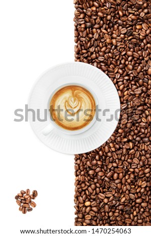 Cup of a Late on a white plate suraunded by coffee beans on the white background bunch of coffee beans in the left bottom corner isolated on the white background, cup facing 8 o'clock
