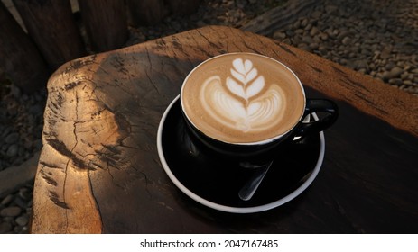 cup of latte art coffee on wooden background - Shutterstock ID 2047167485