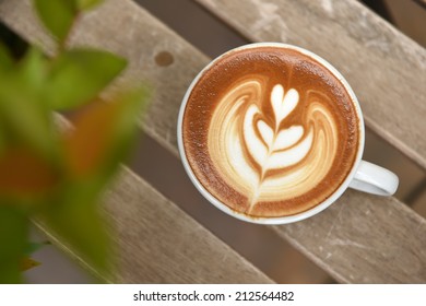 A Cup Of Latte Art Coffee On Table