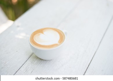 Cup Of Latte Art Heart Shape Coffee On White Table.