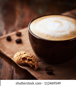 Cup of latte coffee with biscotti. Symbolic image. Rustic wooden background. Close up.  - Shutterstock ID 112469549