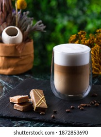 a cup of latte on the table with candy