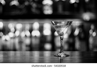 a cup of martini with olive on a old pub black and white conversion - Powered by Shutterstock