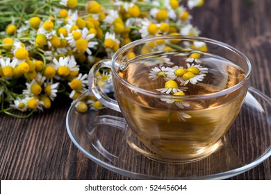 Cup of medicinal chamomile tea on a wooden