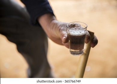 Cup Of Mezcal Beverage In Hand, From Oaxaca Mexico 