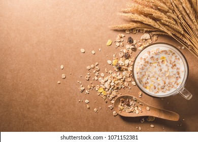 A cup of milk with cereal on wooden table. Healthy breakfast concept. copy space. top view - Powered by Shutterstock