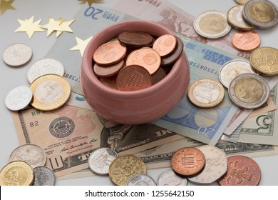 Cup Of Plenty, Symbol Of Wealth And Abundance. Treasure Concept. Coins And Banknotes From Different Countries.