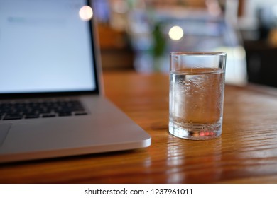 A Cup Of Pure Water With Laptop On Table. Royalty High Quality Free Stock Image Of Glass Of Water With Laptop For Working In A Coffee Shop. Beautiful Workspace With Retro And Vintage Style  