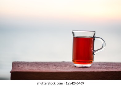 A Cup Of Red Tea By The Sunset