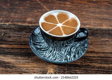Cup of salep milky traditional hot drink of Turkey with cinnamon served in a porcelain cup.
