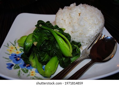 Cup Of Steamed White Rice With Steamed Buk Choy Or Pechay, Also Known As Chinese Cabbage.