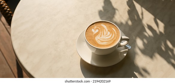 Cup of tasty coffee on table in outdoor cafe - Powered by Shutterstock