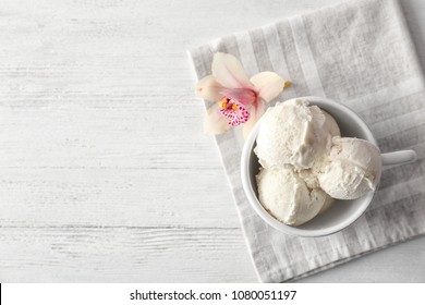 Cup With Tasty Vanilla Ice Cream On Wooden Background, Top View