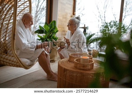 Cup of tea after a spa session. Seniors sitting in a relaxation room.