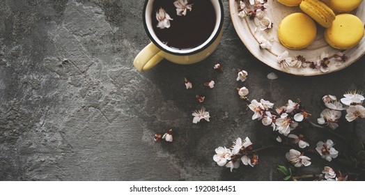 Cup Of Tea, Almond Macaroons, Pink Apple Branch. Spring Homely Scene. Flat Lay, Top View.