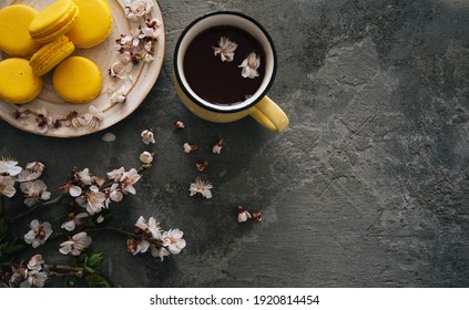 Cup Of Tea, Almond Macaroons, Pink Apple Branch. Spring Homely Scene. Flat Lay, Top View.