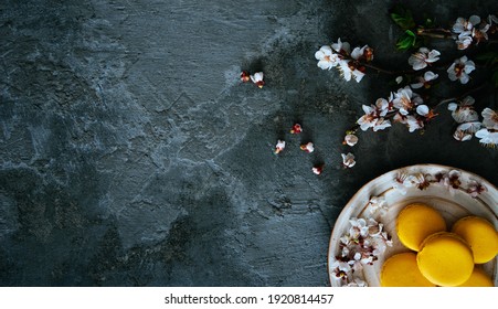 Cup Of Tea, Almond Macaroons, Pink Apple Branch. Spring Homely Scene. Flat Lay, Top View.