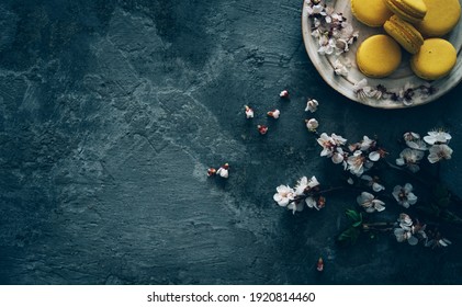 Cup Of Tea, Almond Macaroons, Pink Apple Branch. Spring Homely Scene. Flat Lay, Top View.