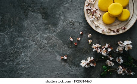 Cup Of Tea, Almond Macaroons, Pink Apple Branch. Spring Homely Scene. Flat Lay, Top View.