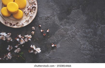 Cup Of Tea, Almond Macaroons, Pink Apple Branch. Spring Homely Scene. Flat Lay, Top View.