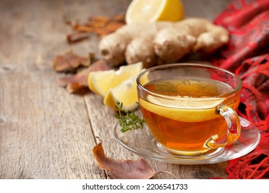 a cup of tea with autumn entourage on an old wooden background. - Shutterstock ID 2206541733
