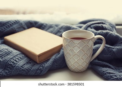 Cup Of Tea, Book And Warm Knitted Plaid On Windowsill, Close Up