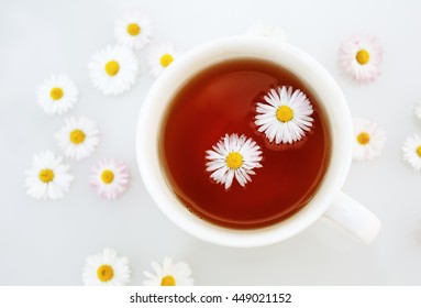 Cup Of Tea With Camomile Flowers. Shallow Depth Of Field. Selective Focus. Top View.